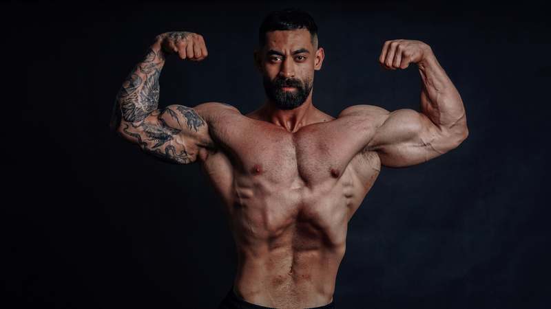 Athletic man in gym lifting weights with energy and focus, symbolizing natural testosterone support