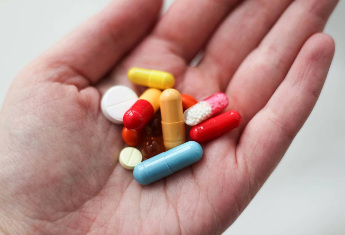 safe testosterone boosters for men: bottles of verified natural supplements next to whole foods like eggs, spinach, and salmon